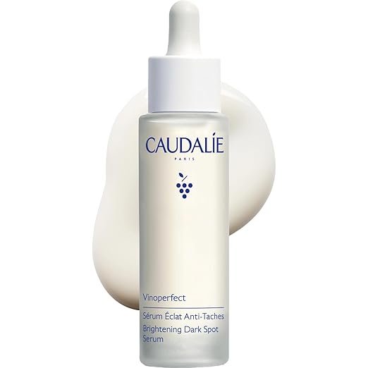 A clear glass dropper bottle of Caudalie Vinoperfect Radiance Serum, displaying natural, brightening luxury skincare products.